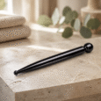 Black Facial Massage Wand displayed in a professional treatment room